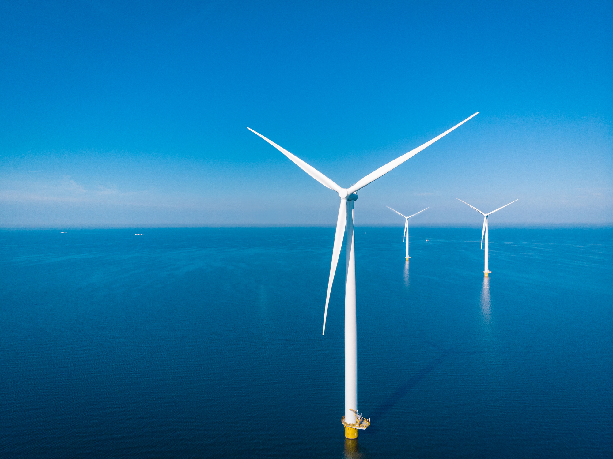 offshore wind farm against a blue sky