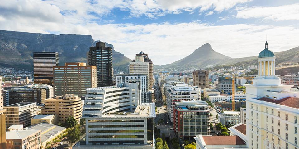 View of South African city with high rise buildings and mountains in the background