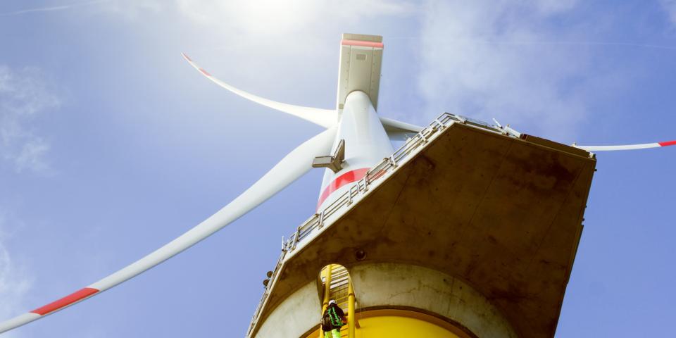 looking up at a wind turbine