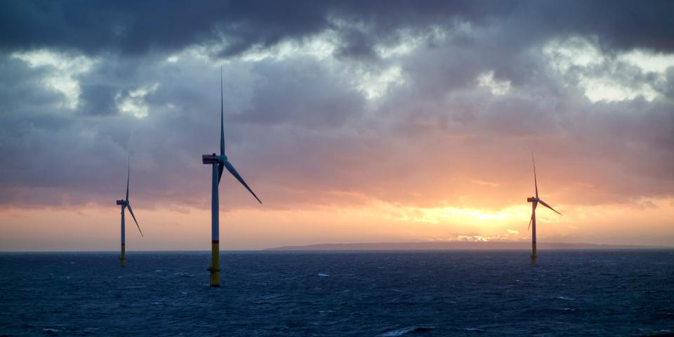 Offshore wind-farm in sunset and clouds
