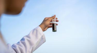 Scientist holding out a test tube