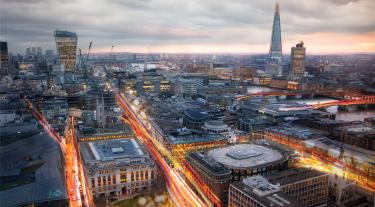 view of London cityscape at dusk with roads lit up