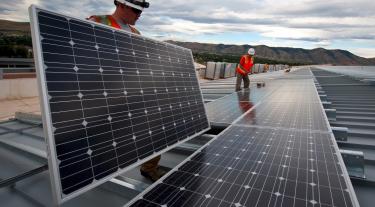 2 figures installing solar panels
