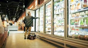 Man looking in a supermarket fridge