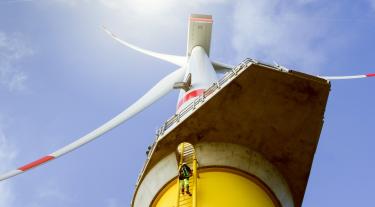 Manual high worker climbing on wind-turbine